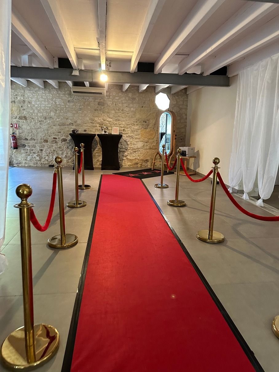 Tapis rouge et potelets dorés à l’entrée d’une salle